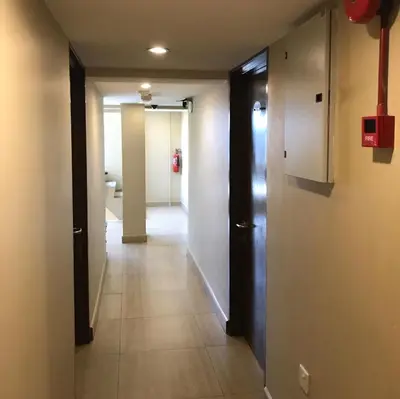 a hallway with two doors and a tile floor at Se One Hotel in Butterworth