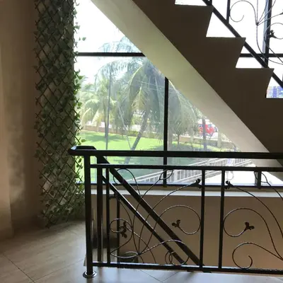 a glass table in front of a large window at Se One Hotel in Butterworth