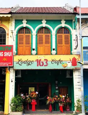 a building with a sign in front of it at Lodge 163 Ventures in Ipoh