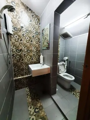 a bathroom with a sink and a toilet at Lodge 163 Ventures in Ipoh