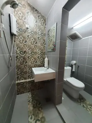 a bathroom with a sink and a toilet at Lodge 163 Ventures in Ipoh