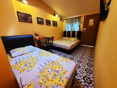 a room with two beds with balloons on them at Lodge 163 Ventures in Ipoh