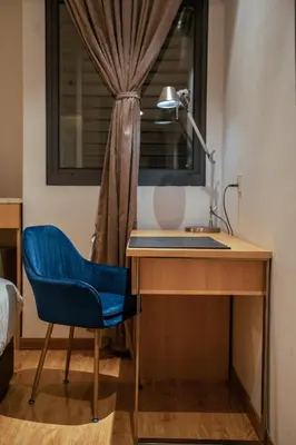 a desk with a blue chair next to a window at Summer Tree Hotel Penang in George Town
