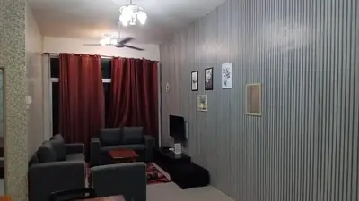 a living room with chairs and a television in a room at Astana Barrington Square Goldenhills Pasar Malam Cameron Highlands in Cameron Highlands
