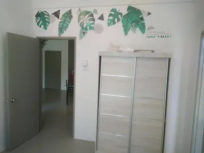 a room with a cabinet with leaves on the wall at Astana Barrington Square Goldenhills Pasar Malam Cameron Highlands in Cameron Highlands