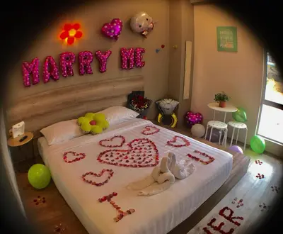 a bedroom with a bed with hearts and a happy me sign at Hotel Flora Plus in Cameron Highlands