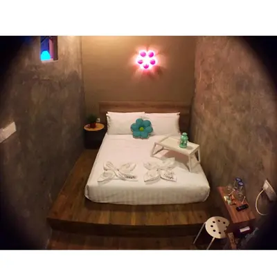 a bedroom with a bed with a teddy bear on it at Hotel Flora Plus in Cameron Highlands