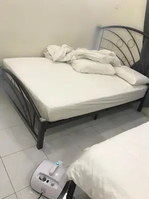 a bed with a video game controller on the floor at 1248 Cozy Home in Ipoh