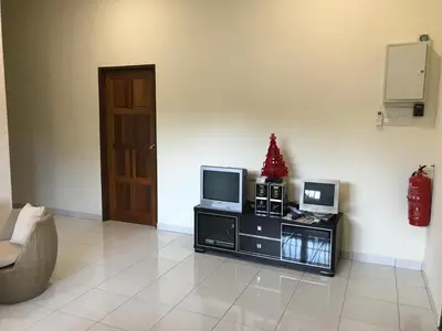 a living room with a television and a christmas tree at 1248 Cozy Home in Ipoh