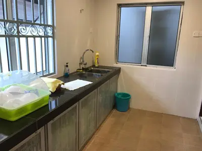 a kitchen counter with a sink and a window at 1248 Cozy Home in Ipoh