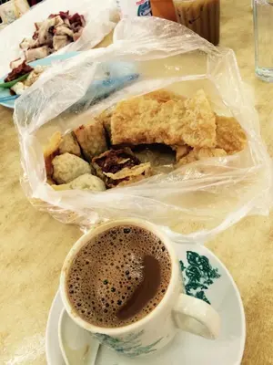 a cup of coffee and a plate of food at 1248 Cozy Home in Ipoh