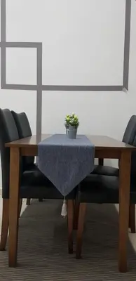 a dining room table with a blue table cloth on it at Fahaz Lumut Homestay in Lumut