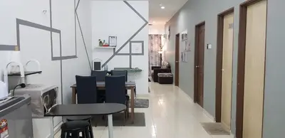 a dining room with a table and blue chairs at Fahaz Lumut Homestay in Lumut