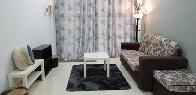 a living room with a couch and a table at Fahaz Lumut Homestay in Lumut