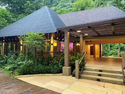 a house with a porch and stairs in front of it at The Banjaran Hotsprings Retreat in Ipoh