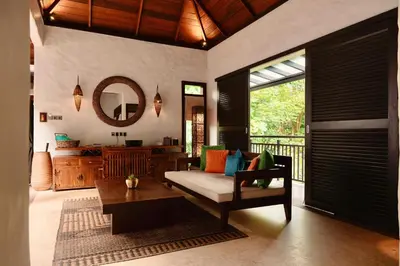 a living room with a couch and a table at The Banjaran Hotsprings Retreat in Ipoh