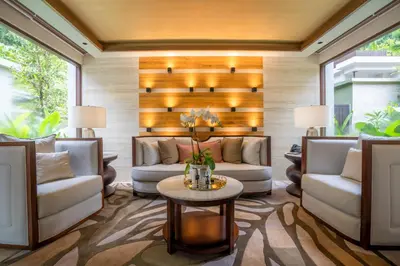 a living room with couches and a table at The Banjaran Hotsprings Retreat in Ipoh