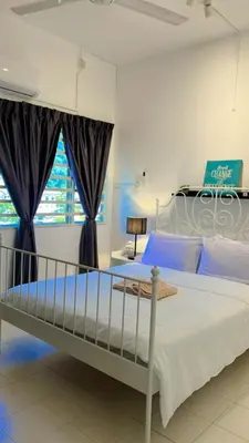 a bedroom with a large bed with blue sheets at Eira Homestay Lost World Of Tambun M uslim only in Ipoh