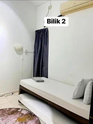 a bed in a room with a sign that reads at Eira Homestay Lost World Of Tambun M uslim only in Ipoh