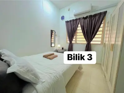 a bedroom with a white bed and a window at Eira Homestay Lost World Of Tambun M uslim only in Ipoh