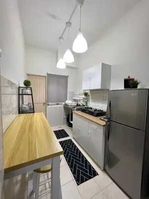 a kitchen with a stainless steel refrigerator and a table at Eira Homestay Lost World Of Tambun M uslim only in Ipoh