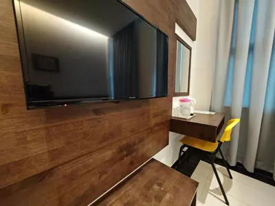 a room with a large flat screen tv on a wall at Citrine Hotel in Seri Iskandar