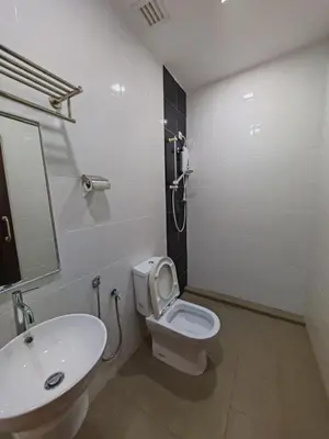 a bathroom with a white toilet and a sink at Citrine Hotel in Seri Iskandar