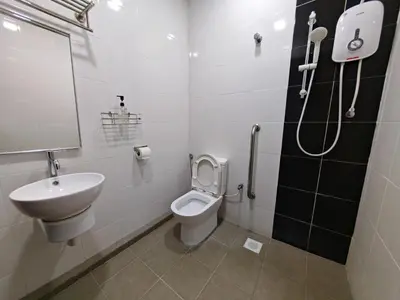 a bathroom with a toilet and a sink and a shower at Citrine Hotel in Seri Iskandar