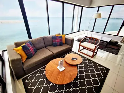 a living room with a couch and a table at Sunrise Gurney in George Town
