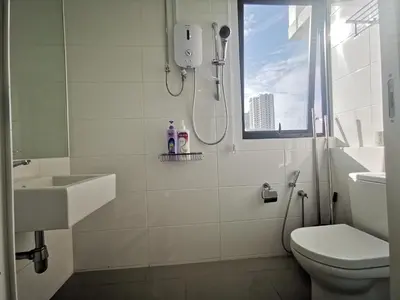 a bathroom with a shower and a toilet and a sink at Sunrise Gurney in George Town