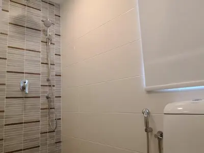a bathroom with a shower and a toilet at Sunrise Gurney in George Town