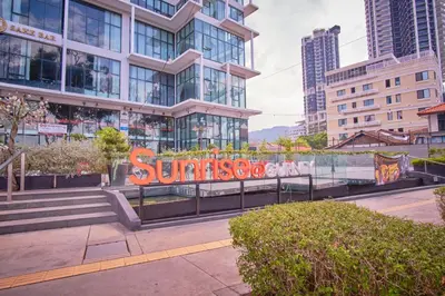 a sign in front of a building with buildings at Sunrise Gurney in George Town