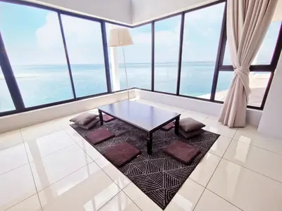 a living room with a table and some windows at Sunrise Gurney in George Town