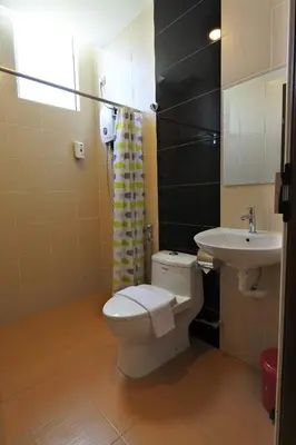 a bathroom with a toilet and a sink at Hotel Dutaria in Ipoh