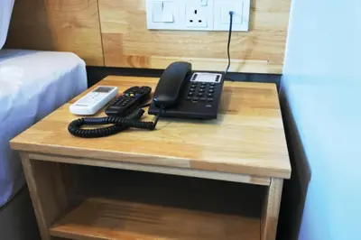a desk with a telephone and a remote control on it at Hotel Dutaria in Ipoh