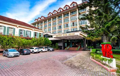 a large hotel with cars parked in front of it at Century Pines Resort Cameron Highlands in Cameron Highlands