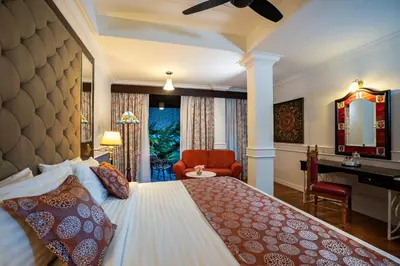 a bedroom with a bed and a desk and a chair at Century Pines Resort Cameron Highlands in Cameron Highlands