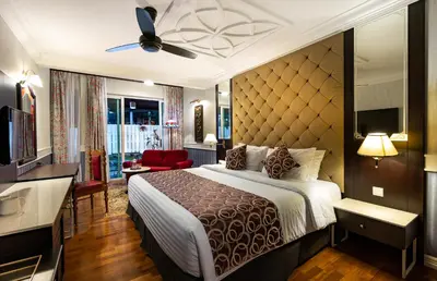 a hotel room with a bed and a television at Century Pines Resort Cameron Highlands in Cameron Highlands