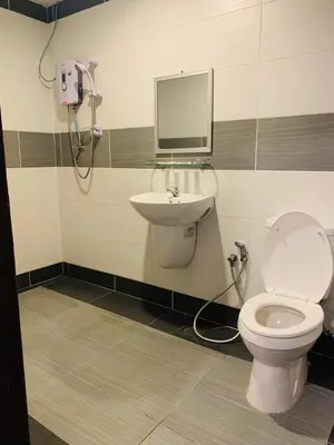 a bathroom with a toilet and a sink at Zermatt Hotel in Cameron Highlands