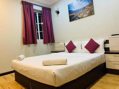 a bedroom with a large bed with purple curtains at Zermatt Hotel in Cameron Highlands
