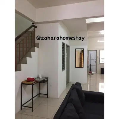 a living room with a couch and a staircase at Zahara Homestay in Cameron Highlands