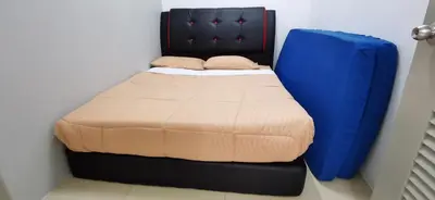 a bed in a room with a blue bed frame at My Home Apartment @ Golden Hills in Cameron Highlands