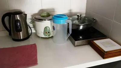 a kitchen counter with a coffee maker and a toaster at My Home Apartment @ Golden Hills in Cameron Highlands
