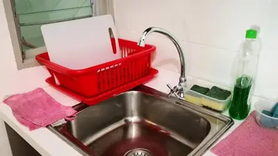 a kitchen sink with a red basket on top of it at My Home Apartment @ Golden Hills in Cameron Highlands