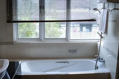 a bath tub in a bathroom with a window at Heritage Hotel Cameron Highlands in Cameron Highlands
