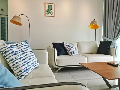 a living room with two couches and a table at Southbay Plaza Condominium in Bayan Lepas