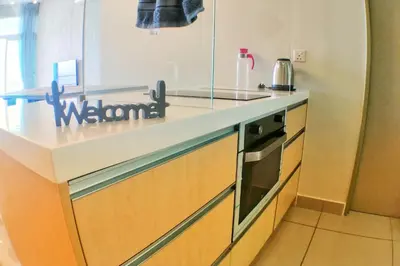 a kitchen with a counter top and a stove at Southbay Plaza Condominium in Bayan Lepas