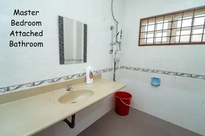a bathroom with a sink and a mirror at GLYSM Tambun Stay in Ipoh