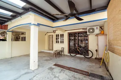 a room with a ceiling fan and a bike in a room at GLYSM Tambun Stay in Ipoh