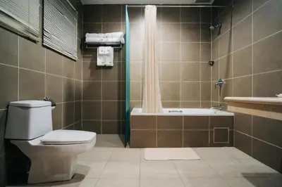 a bathroom with a toilet and a bath tub at Hotel De' La Ferns, Cameron Highlands in Cameron Highlands